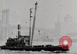 Image of New York Harbor and Brooklyn Bridge seen from steamship New York City USA, 1917, second 35 stock footage video 65675025400