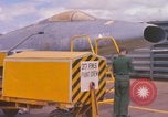 Image of Airman paints F100D plane Phu Cat Vietnam, 1968, second 6 stock footage video 65675025448