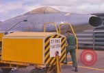 Image of Airman paints F100D plane Phu Cat Vietnam, 1968, second 8 stock footage video 65675025448