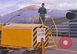 Image of Airman paints F100D plane Phu Cat Vietnam, 1968, second 14 stock footage video 65675025448