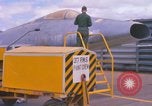 Image of Airman paints F100D plane Phu Cat Vietnam, 1968, second 15 stock footage video 65675025448