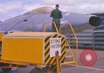 Image of Airman paints F100D plane Phu Cat Vietnam, 1968, second 16 stock footage video 65675025448