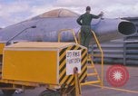Image of Airman paints F100D plane Phu Cat Vietnam, 1968, second 20 stock footage video 65675025448