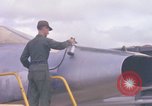 Image of Airman paints F100D plane Phu Cat Vietnam, 1968, second 22 stock footage video 65675025448