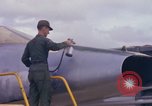 Image of Airman paints F100D plane Phu Cat Vietnam, 1968, second 24 stock footage video 65675025448
