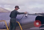 Image of Airman paints F100D plane Phu Cat Vietnam, 1968, second 25 stock footage video 65675025448