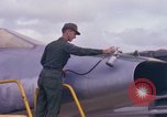 Image of Airman paints F100D plane Phu Cat Vietnam, 1968, second 26 stock footage video 65675025448
