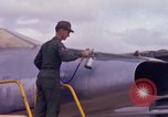 Image of Airman paints F100D plane Phu Cat Vietnam, 1968, second 30 stock footage video 65675025448