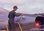 Image of Airman paints F100D plane Phu Cat Vietnam, 1968, second 32 stock footage video 65675025448