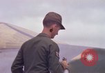 Image of Airman paints F100D plane Phu Cat Vietnam, 1968, second 33 stock footage video 65675025448