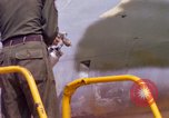 Image of Airman paints F100D plane Phu Cat Vietnam, 1968, second 42 stock footage video 65675025448
