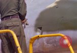 Image of Airman paints F100D plane Phu Cat Vietnam, 1968, second 43 stock footage video 65675025448