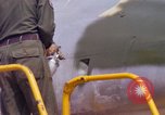 Image of Airman paints F100D plane Phu Cat Vietnam, 1968, second 44 stock footage video 65675025448