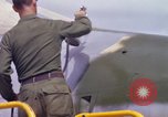 Image of Airman paints F100D plane Phu Cat Vietnam, 1968, second 48 stock footage video 65675025448