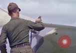 Image of Airman paints F100D plane Phu Cat Vietnam, 1968, second 50 stock footage video 65675025448