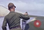 Image of Airman paints F100D plane Phu Cat Vietnam, 1968, second 51 stock footage video 65675025448