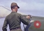 Image of Airman paints F100D plane Phu Cat Vietnam, 1968, second 55 stock footage video 65675025448
