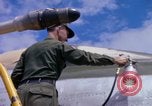 Image of Airman paints F100D plane Phu Cat Vietnam, 1968, second 62 stock footage video 65675025448