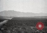 Image of Holt tractor pulling trucks through wet sand Nevada United States USA, 1919, second 1 stock footage video 65675025558