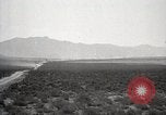 Image of Holt tractor pulling trucks through wet sand Nevada United States USA, 1919, second 3 stock footage video 65675025558