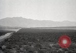 Image of Holt tractor pulling trucks through wet sand Nevada United States USA, 1919, second 5 stock footage video 65675025558