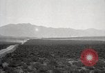 Image of Holt tractor pulling trucks through wet sand Nevada United States USA, 1919, second 6 stock footage video 65675025558
