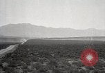 Image of Holt tractor pulling trucks through wet sand Nevada United States USA, 1919, second 23 stock footage video 65675025558