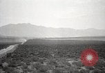 Image of Holt tractor pulling trucks through wet sand Nevada United States USA, 1919, second 28 stock footage video 65675025558