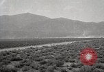 Image of Holt tractor pulling trucks through wet sand Nevada United States USA, 1919, second 62 stock footage video 65675025558