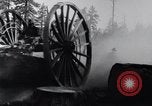 Image of large wheeled rig hauling cut logs United States USA, 1920, second 13 stock footage video 65675025658