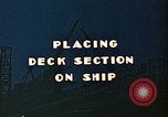Image of Mobile cranes move ship's deck section at shipyard in World War California United States USA, 1942, second 3 stock footage video 65675025791
