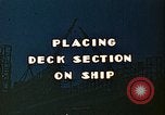 Image of Mobile cranes move ship's deck section at shipyard in World War California United States USA, 1942, second 4 stock footage video 65675025791