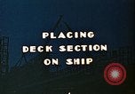 Image of Mobile cranes move ship's deck section at shipyard in World War California United States USA, 1942, second 5 stock footage video 65675025791