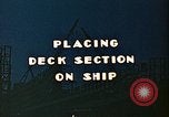 Image of Mobile cranes move ship's deck section at shipyard in World War California United States USA, 1942, second 6 stock footage video 65675025791