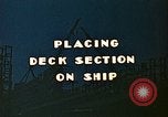 Image of Mobile cranes move ship's deck section at shipyard in World War California United States USA, 1942, second 7 stock footage video 65675025791