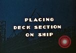 Image of Mobile cranes move ship's deck section at shipyard in World War California United States USA, 1942, second 8 stock footage video 65675025791