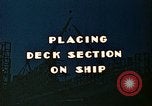 Image of Mobile cranes move ship's deck section at shipyard in World War California United States USA, 1942, second 9 stock footage video 65675025791