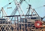 Image of Mobile cranes move ship's deck section at shipyard in World War California United States USA, 1942, second 10 stock footage video 65675025791