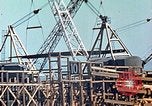 Image of Mobile cranes move ship's deck section at shipyard in World War California United States USA, 1942, second 11 stock footage video 65675025791