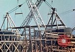 Image of Mobile cranes move ship's deck section at shipyard in World War California United States USA, 1942, second 12 stock footage video 65675025791