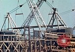 Image of Mobile cranes move ship's deck section at shipyard in World War California United States USA, 1942, second 13 stock footage video 65675025791
