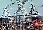 Image of Mobile cranes move ship's deck section at shipyard in World War California United States USA, 1942, second 14 stock footage video 65675025791