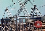 Image of Mobile cranes move ship's deck section at shipyard in World War California United States USA, 1942, second 16 stock footage video 65675025791