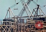 Image of Mobile cranes move ship's deck section at shipyard in World War California United States USA, 1942, second 18 stock footage video 65675025791