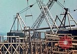 Image of Mobile cranes move ship's deck section at shipyard in World War California United States USA, 1942, second 19 stock footage video 65675025791