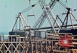 Image of Mobile cranes move ship's deck section at shipyard in World War California United States USA, 1942, second 20 stock footage video 65675025791
