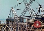 Image of Mobile cranes move ship's deck section at shipyard in World War California United States USA, 1942, second 21 stock footage video 65675025791
