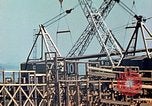 Image of Mobile cranes move ship's deck section at shipyard in World War California United States USA, 1942, second 22 stock footage video 65675025791
