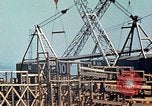 Image of Mobile cranes move ship's deck section at shipyard in World War California United States USA, 1942, second 23 stock footage video 65675025791