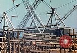 Image of Mobile cranes move ship's deck section at shipyard in World War California United States USA, 1942, second 24 stock footage video 65675025791